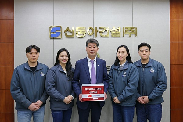 ▲ 진현기 신동아건설 대표(가운데)가 임직원들이 모은 피해복구 성금 모금함을 들고 직원들과 기념 촬영을 하고 있다